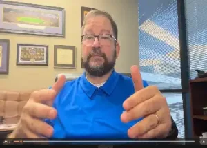 Al Schiebel discussing the difference between health insurance benchmarking and actual cost-control strategies. Text overlay: "Averages don't control costs."